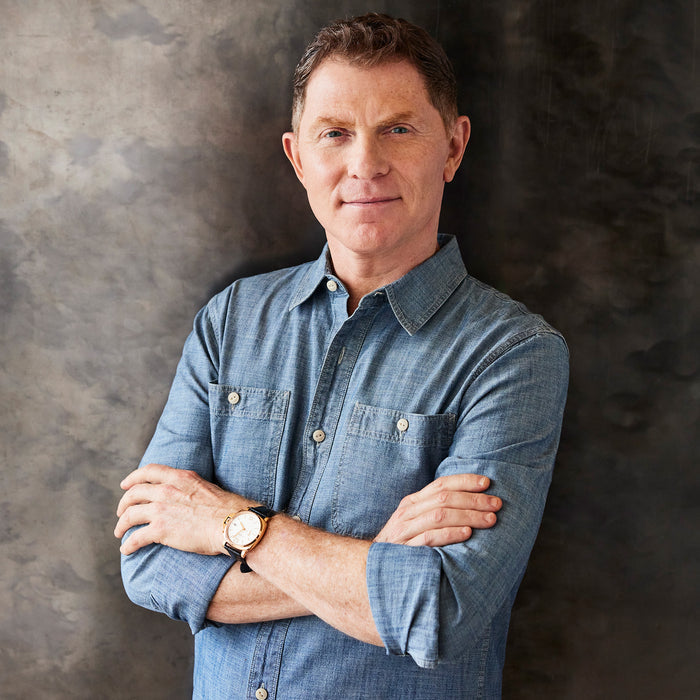 Man in blue shirt stands in front of gray background with Bobby Flay by GreenPan 6-quart stockpot.