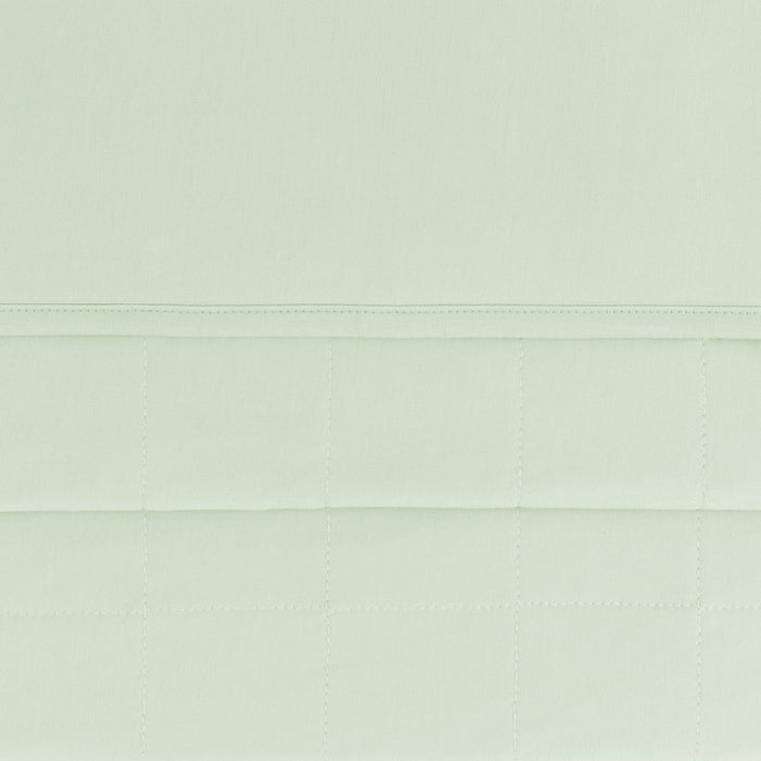 close up of the quilted backing and smooth top layer of the Toddler Blanket in Basil 1.0
