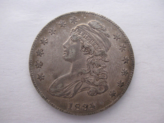 1834 Capped Bust Half Dollar. AU-50 | Of Coins & Crystals