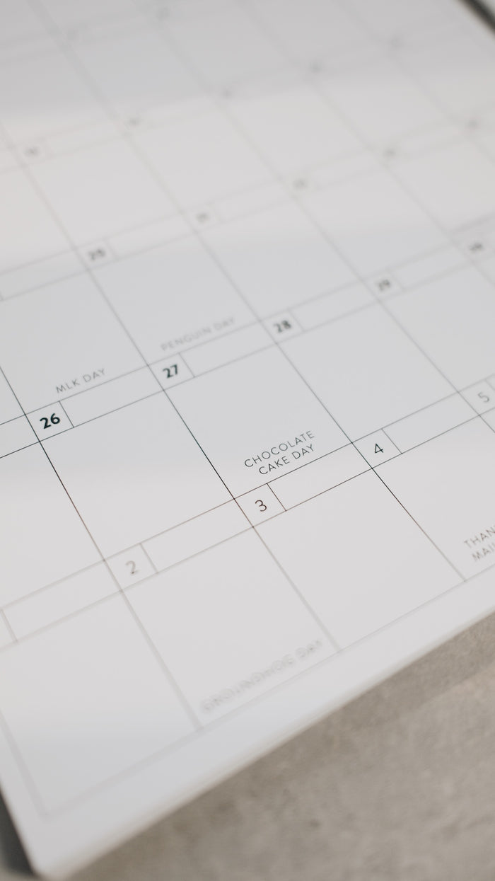 Calendar with a focus on a specific date, showing 'Chocolate Cake Day' written on it.