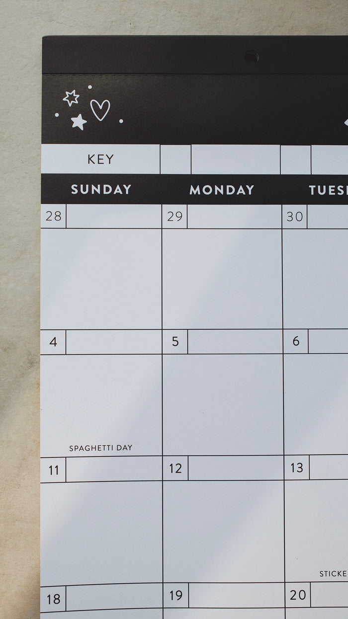Left-hand corner of a calendar showing a doodle of a heart and stars above Sunday