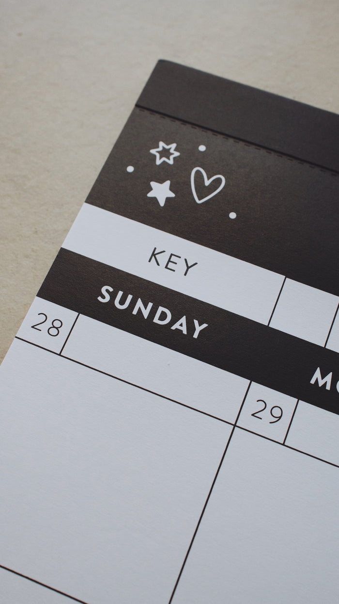 Left-hand corner of a calendar showing a doodle of a heart and stars above Sunday
