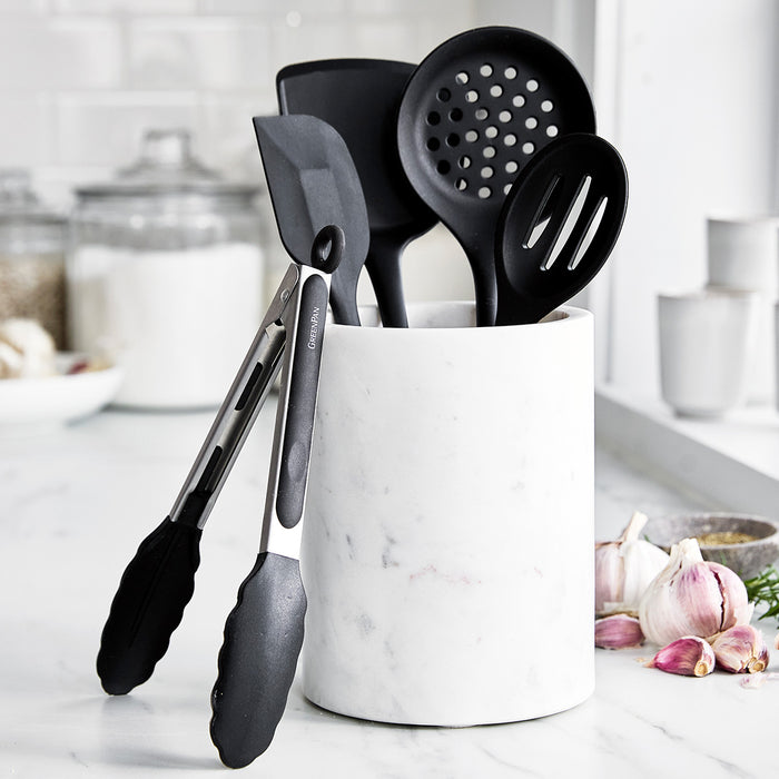 Black 5-piece silicone utensil set with marble holder on a white countertop.