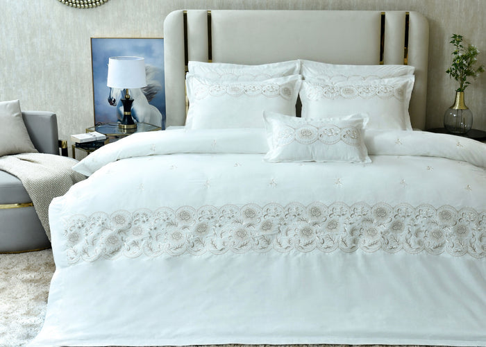 White queen duvet cover set with embroidered floral borders and matching pillow shams