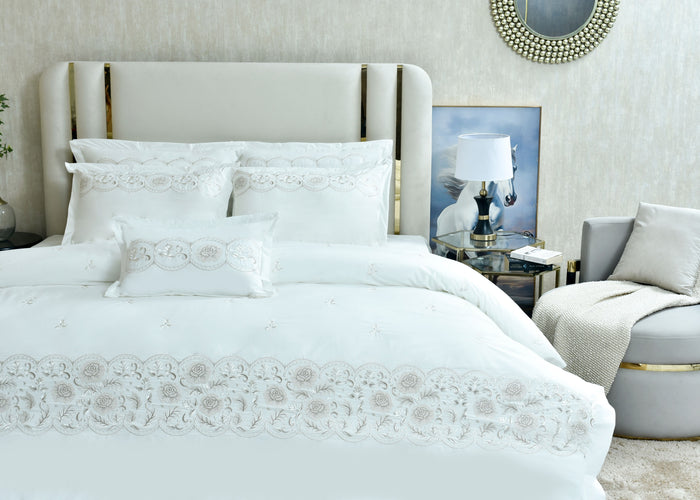 White queen duvet cover set featuring embroidered medallion motifs on duvet and pillow shams