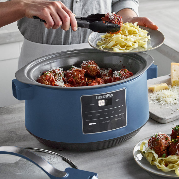 Blue GreenPan slow cooker with pasta and meatballs on a kitchen counter