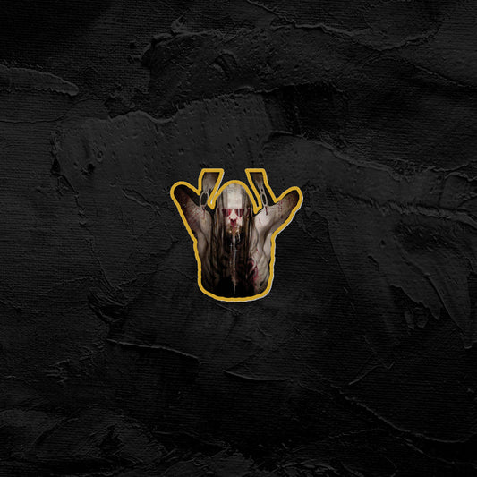 A stylized Sadistik graphic shows a pale, monstrous figure with elongated fingers and yellow enamel claws raised near its face, set against a textured dark background and outlined in yellow.