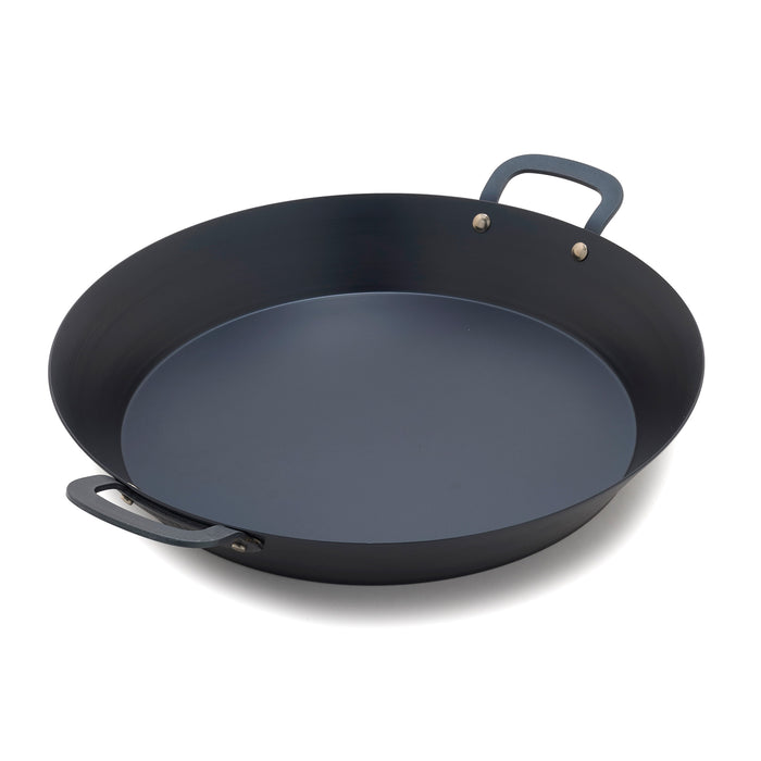 Carbon steel paella pan with two handles on a white background.