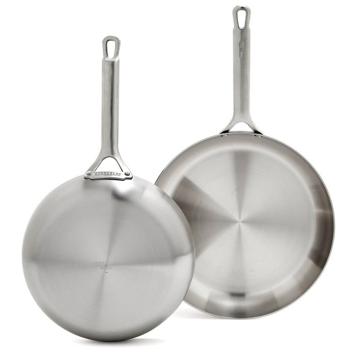 Set of two stainless steel frypans, 10-inch and 12-inch, with polished finish and metal handles.