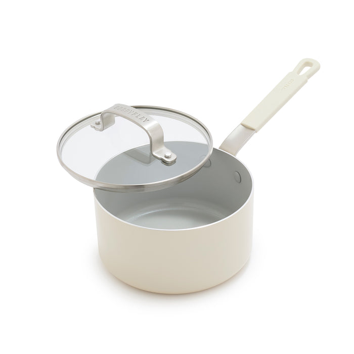 Cream ceramic 1.6-quart saucepan with a glass lid, shown slightly open.