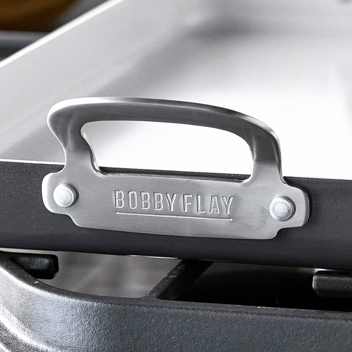 Graphite-colored GreenPan griddle handle with Bobby Flay engraving, ceramic, diamond-infused surface visible.