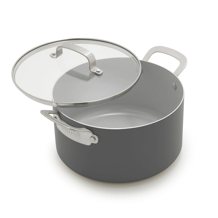 Graphite nonstick stockpot with glass lid and metal handles, 6-quart size, shown on a white background.