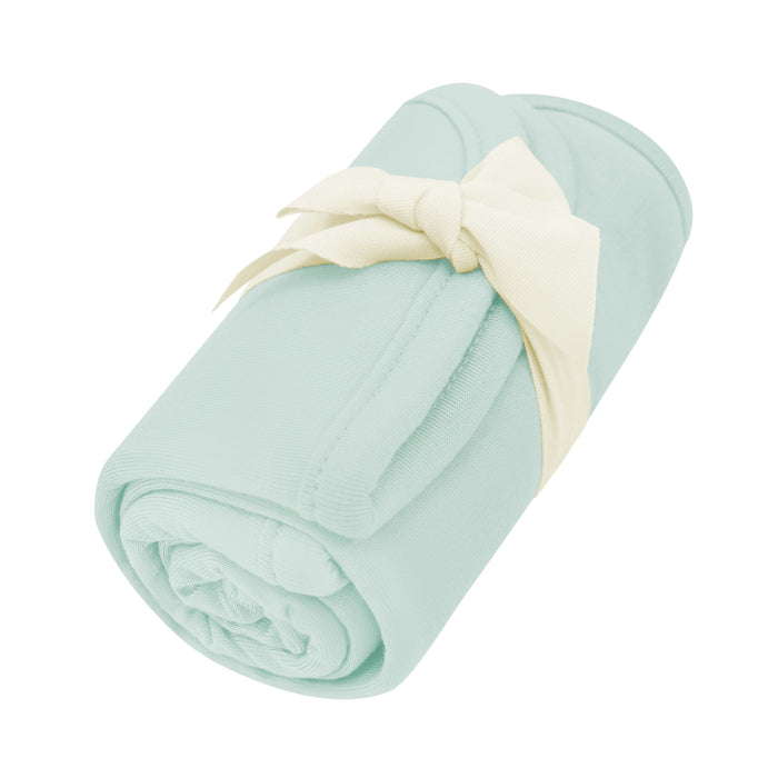 Rolled up Burp Cloth in Sage with bow tied around it