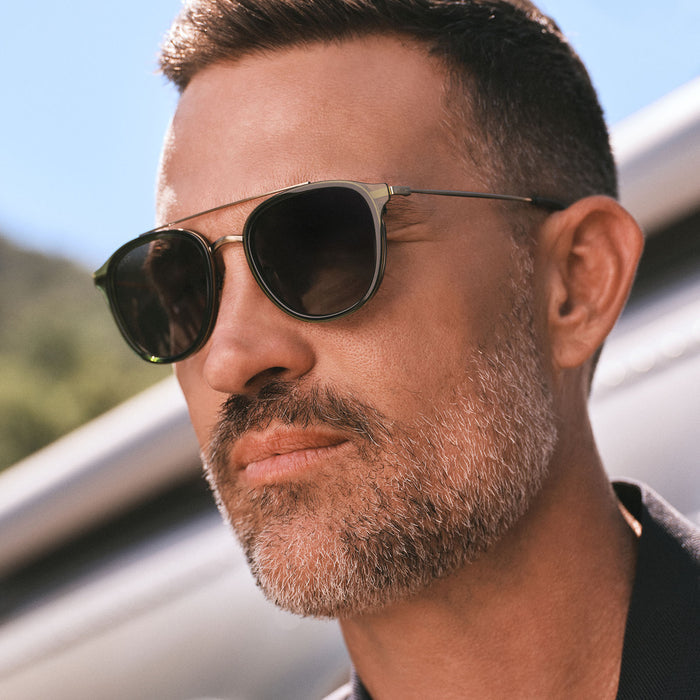 lifestyle - male wearing diff eyewear featuring the camden aviator sunglasses with a dark olive crystal frame and g15 polarized lenses detailed view