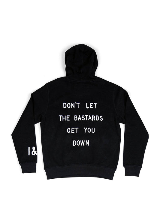 Black hoodie with bold white text saying, "DON'T LET THE BASTARDS GET YOU DOWN," covering the back. Simple and striking design.