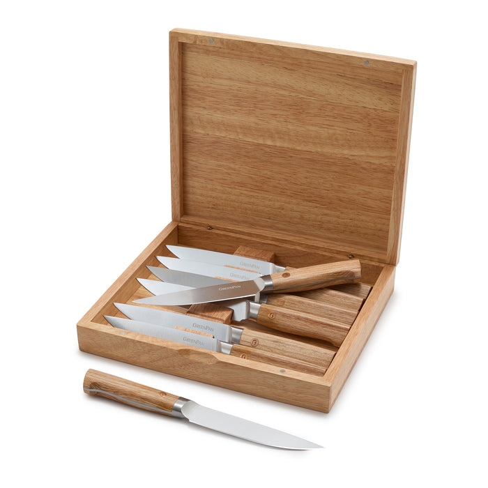 Set of steak knives with wooden handles in a wooden box on a white background