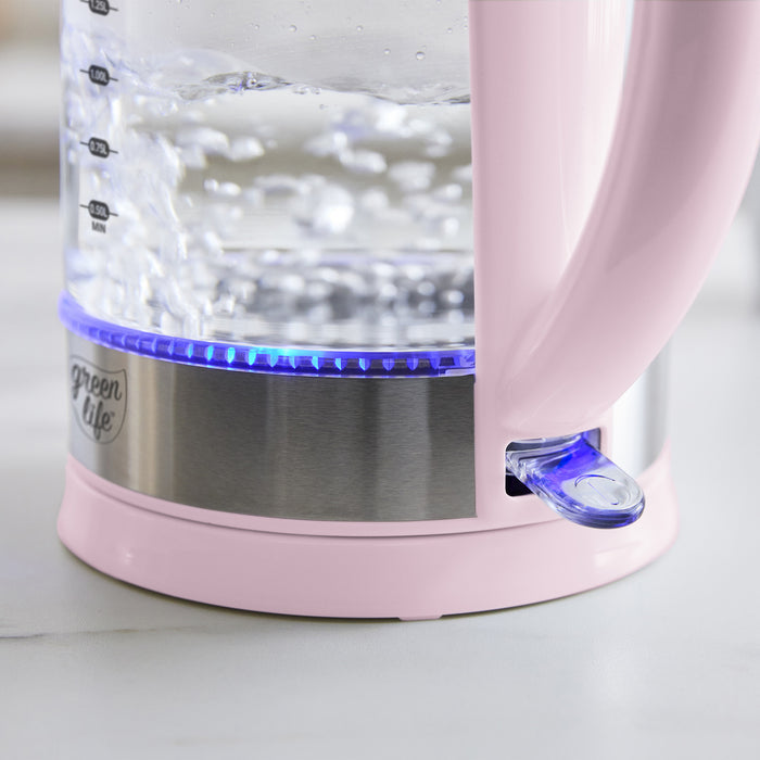 Pink electric glass kettle, 1.7L, boiling water with blue power indicator light on.