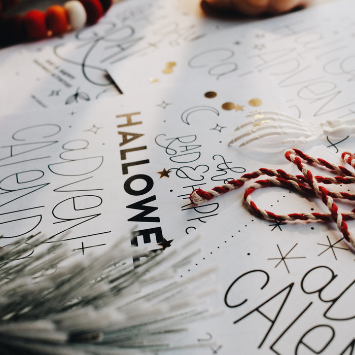 Side view of a Halloween advent calendar page with a red and white string on top