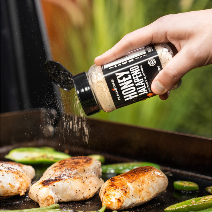 Honey Jalapeno Seasoning put on chicken on a griddle.