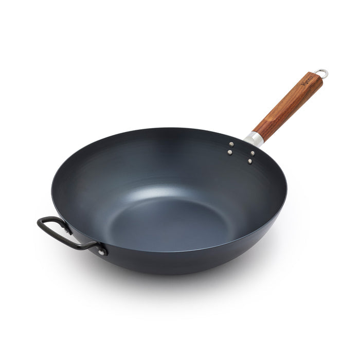 Black wok with a wooden handle on a white background
