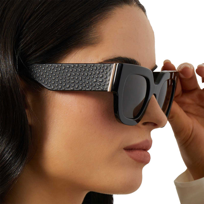 on model - female wearing iconica diff eyewear maren square oversized sunglasses with a black acetate frame and grey polarized lenses detailed view