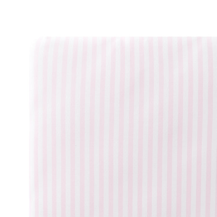 Close up of the Mini Crib Sheet in Small Sakura Stripe on a mattress