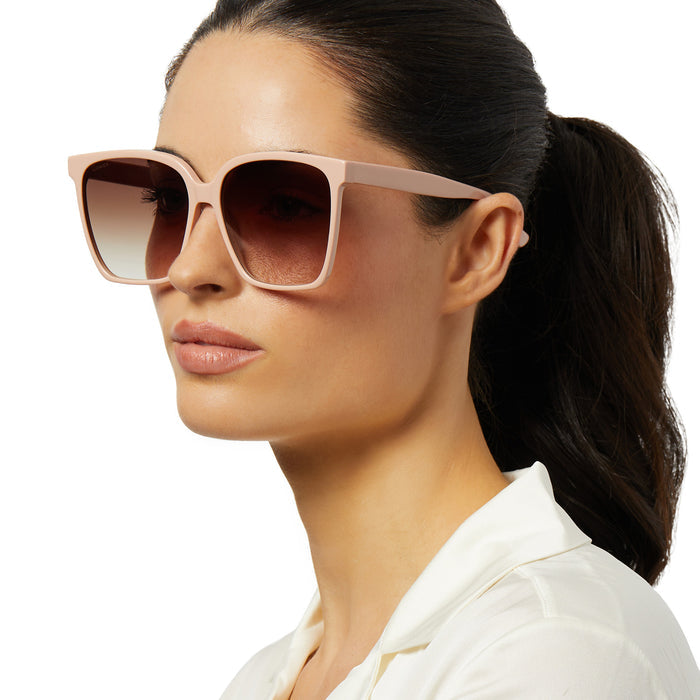 on model - female wearing iconica x diff eyewear naomi square oversized sunglasses with a nude acetate frame and brown gradient polarized lenses angled view