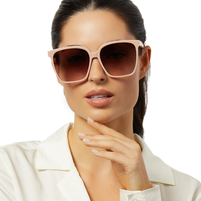 on model - female wearing iconica x diff eyewear naomi square oversized sunglasses with a nude acetate frame and brown gradient polarized lenses front view