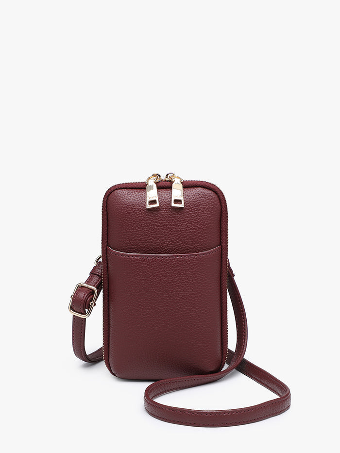 A small plum crossbody phone bag with a front slip pocket, gold-tone zipper pulls, and a matching adjustable shoulder strap.