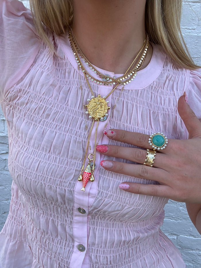 Beachy gold necklaces and rings styled with summer outfit