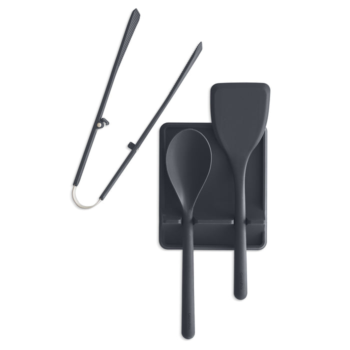Gray platinum silicone utensil set with tongs, spoon, spatula, and tool rest on a white background. Four pieces shown.