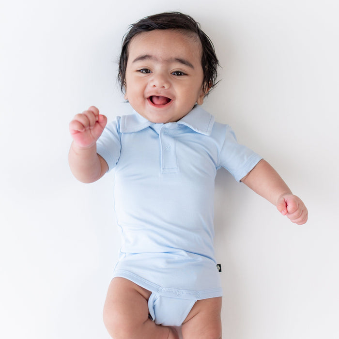 Close up of the Polo Bodysuit in Breeze shown on an infant