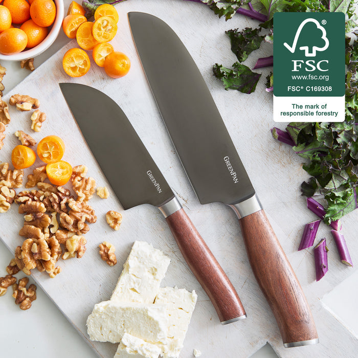 2-piece Santoku knife set with titanium blades and walnut handles on a board, FSC certification logo visible.