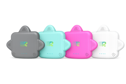 Four small electronic trackers in different colors (gray, mint green, pink, and white) lined up in a row against a plain white background.