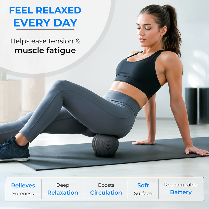 RECOVERO TRIGGER POINT ROLL massage ball used under the thigh by a woman seated on a yoga mat