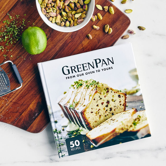 Gray ceramic nonstick 5-piece ovenware set on a table with a lime, zest, pistachios, and a grater.