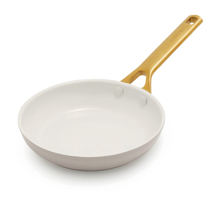 Taupe frypan pan with a gold handle on a white background