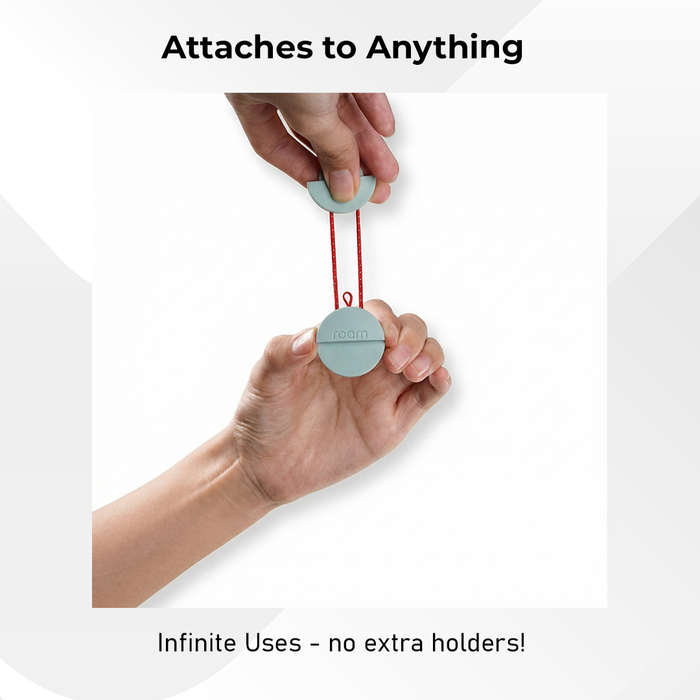 Hands using Roam smart tracker elastic strap to attach sage green compact tracker to any item - Attaches to Anything with Infinite Uses no extra holders needed