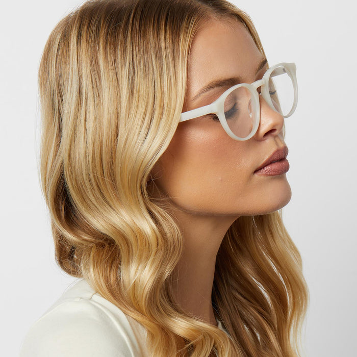 on model - blonde female wearing diff eyewear featuring the sawyer round glasses with a meringue frame and prescription lenses side view