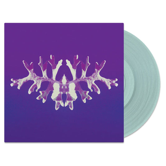 A limited edition pale blue vinyl record by Secret Space, partially in its purple cover, which displays an abstract, symmetrical white and light purple coral or snowflake-like design on the front.