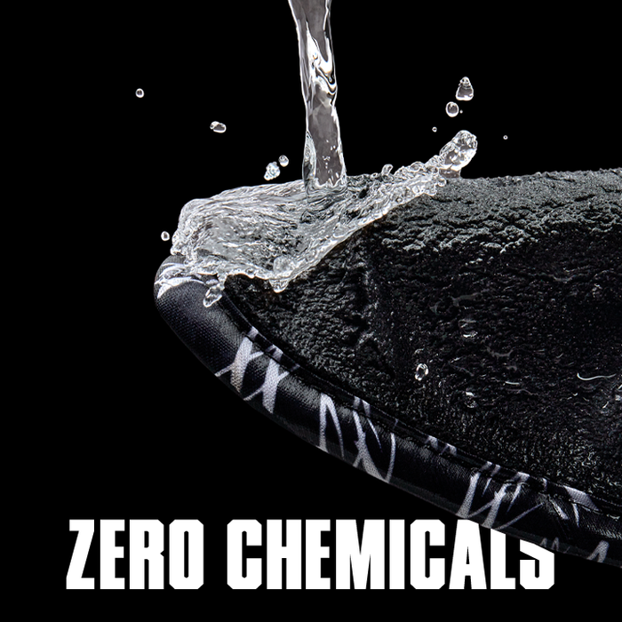 Water droplet falling onto a textured surface with 'Zero Chemicals' text on a black background