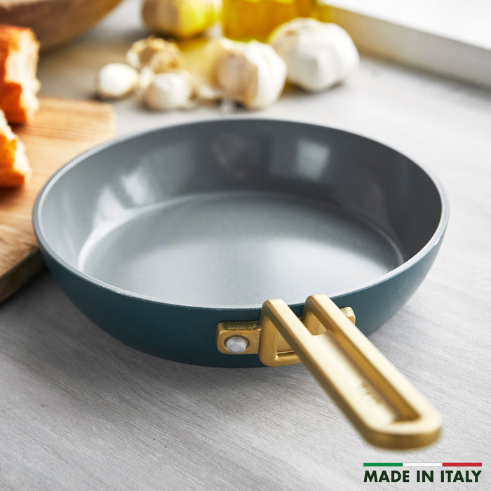 Venetian teal ceramic nonstick 8-inch frypan with gold handle on a counter. Made in Italy.