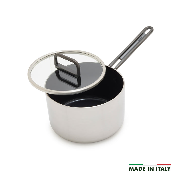 Stainless steel saucepan with ceramic nonstick interior, glass lid, long handle, and Made in Italy label. 2 quart size.