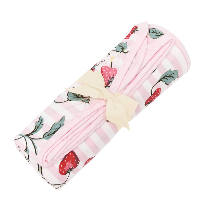 Swaddle Blanket in Strawberry Fields shown in its packaging wrapped in a linen bow