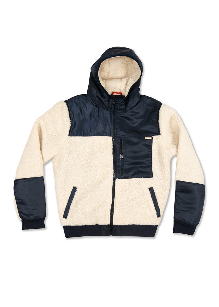 Cream sherpa jacket with navy accents, hood, and zippered pocket. Stylish and warm outerwear for chilly weather.