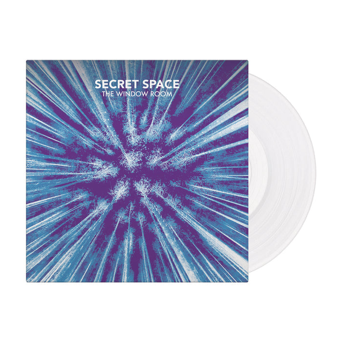 The album cover for Secret Space’s The Window Room showcases blue and purple abstract lines radiating outward. Part of a limited pressing, a clear vinyl record from Secret Space is partially visible behind the cover.