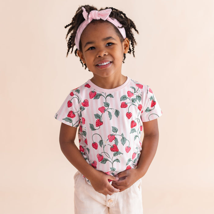 Close up of young girl wearing the Toddler Basic Tee in Strawberry Fields