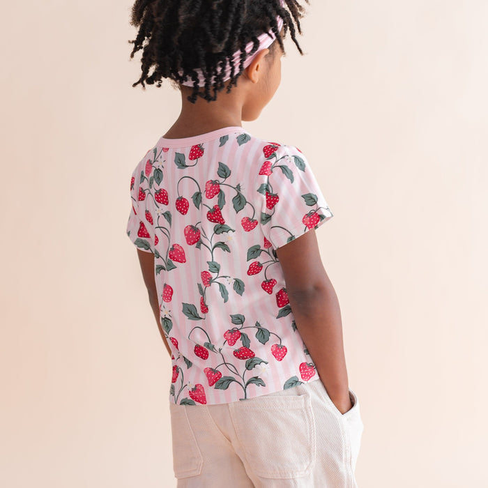 The back of the Toddler Basic Tee in Strawberry Fields shown on a young girl