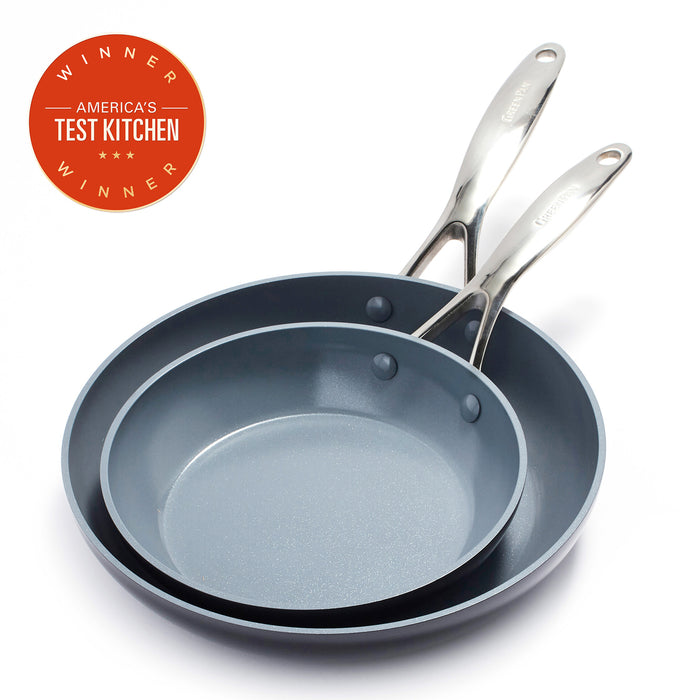Two gray ceramic nonstick frypans with metal handles, overlapping beside an Americas Test Kitchen award.