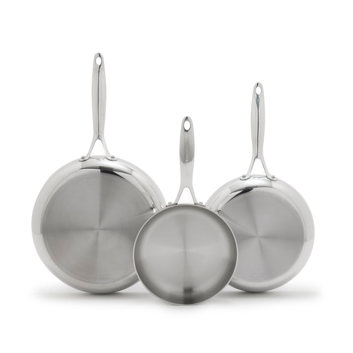 Three stainless steel frypans in 8, 9.5, and 11 sizes overlapping upright on a white background.